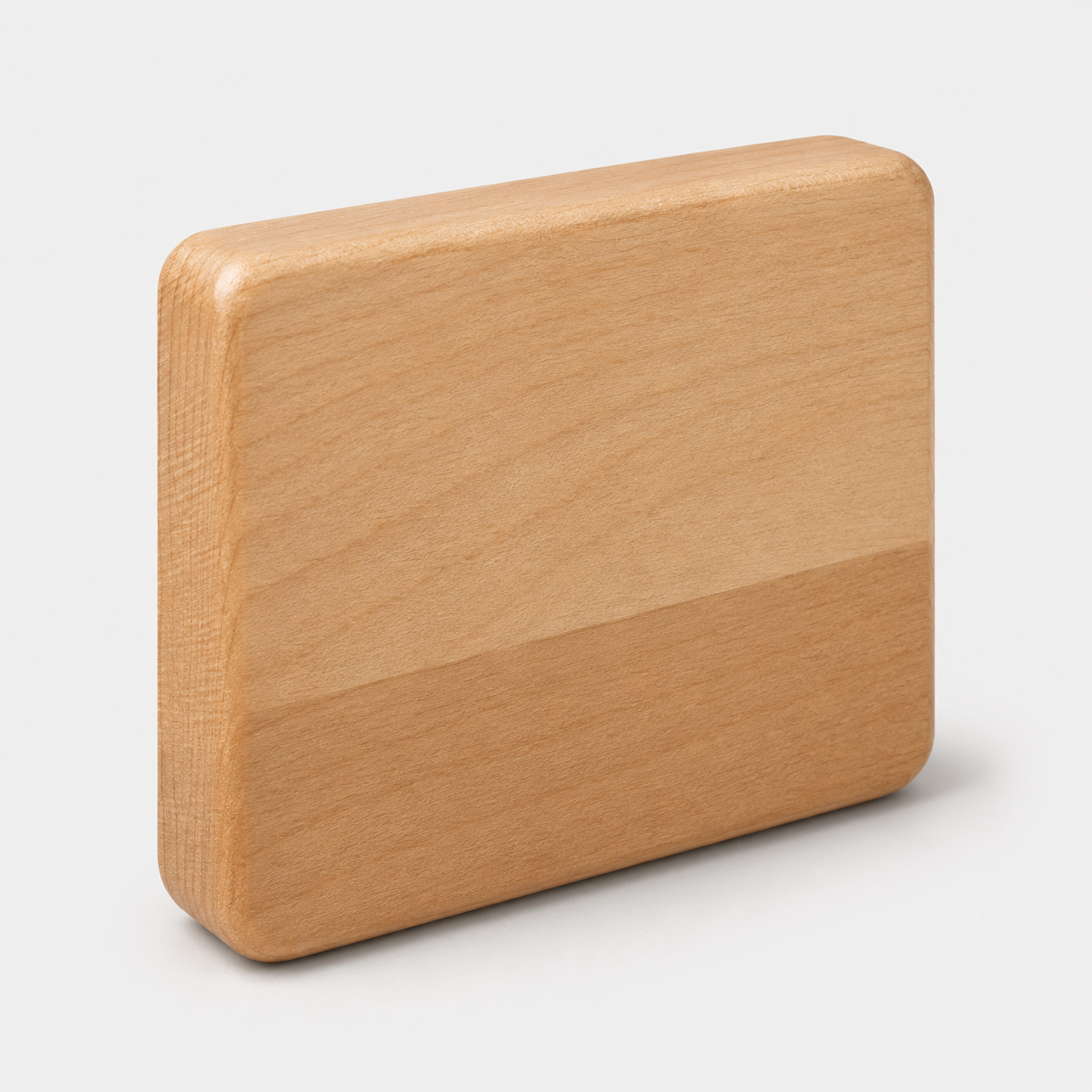 A rectangular wooden block with rounded corners, showing a natural light wood grain texture, photographed on a light gray background.
